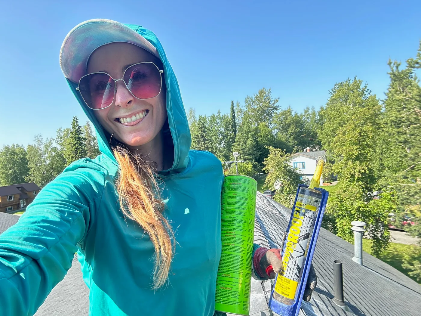 AK Gutter Gals team member with caulk on a roof
