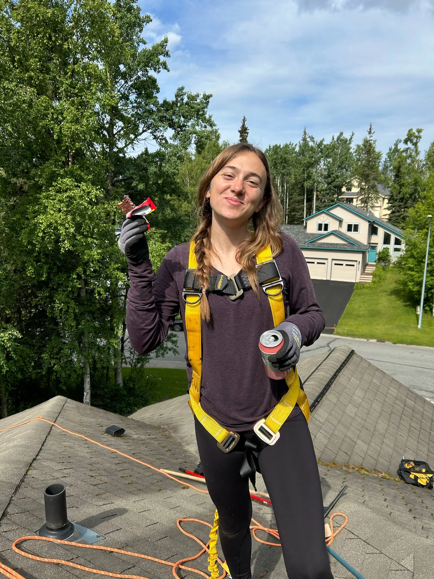 Team member in safety harness on a roof