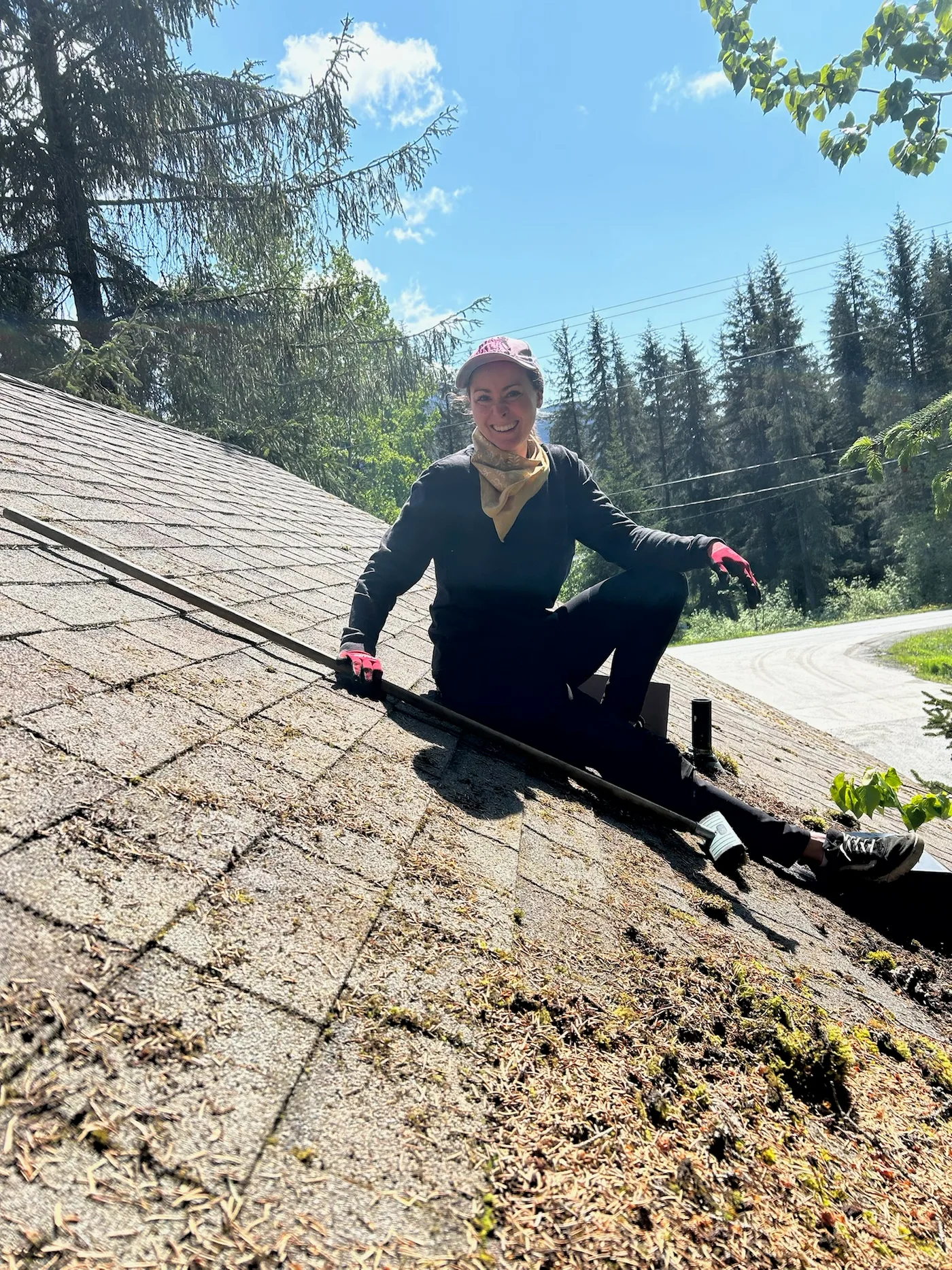 Team member cleaning roof debris