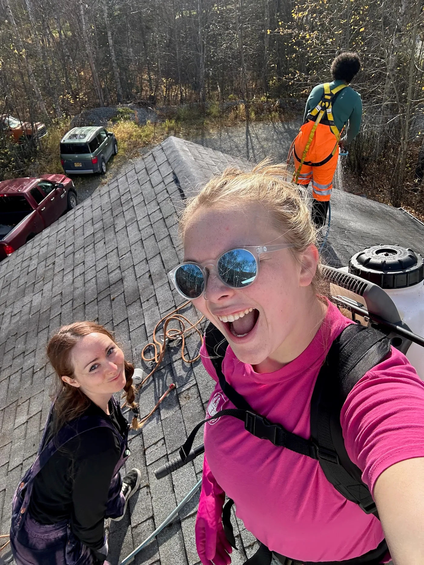 AK Gutter Gals team selfie on a roof